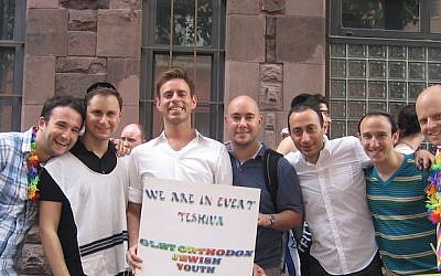 JQY Executive Director Mordechai Levovitz (center, in white shirt holding sign), coordinated "Faith, Desire and Pyschotherapy," a conference held April 19 at Columbia University. (Courtesy of JQY/ via JTA)