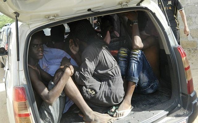 Students of the Garissa University College take shelter in a vehicle after fleeing from an attack by gunmen in Garissa, Kenya, Thursday, April 2, 2015.  (photo credit: AP Photo)