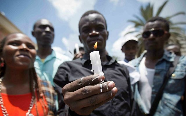 Kenyan students, some wearing black shirts to represent mourning, hold candles as they march in memory of the victims of the Garissa college attack and to protest what they say is a lack of security, in downtown Nairobi, Kenya, Tuesday, April 7, 2015. (AP Photo/Ben Curtis)