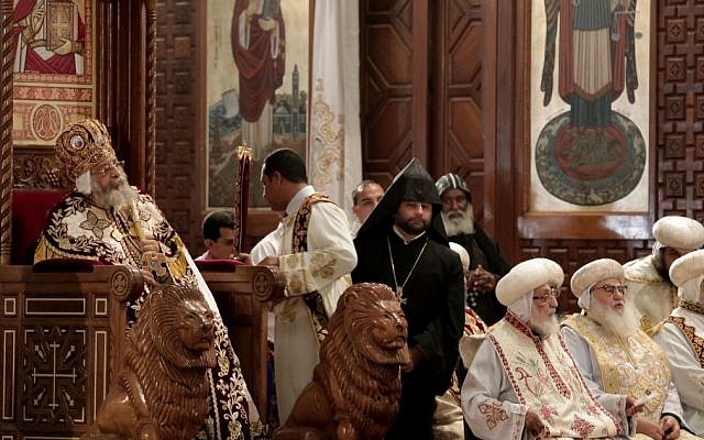 Coptic Pope Tawadros II, left, sits on the throne of Mar Morqos, during the Easter Eve service at St. Mark's Cathedral, in Cairo, Egypt, April 11, 2015. (photo credit: AP/Nariman El-Mofty)