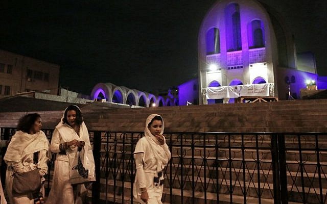 Ethiopian Christian women walk during the Easter Eve service at St. Mark's Cathedral, in Cairo, Egypt, April 11, 2015. (photo credit: AP/Nariman El-Mofty)