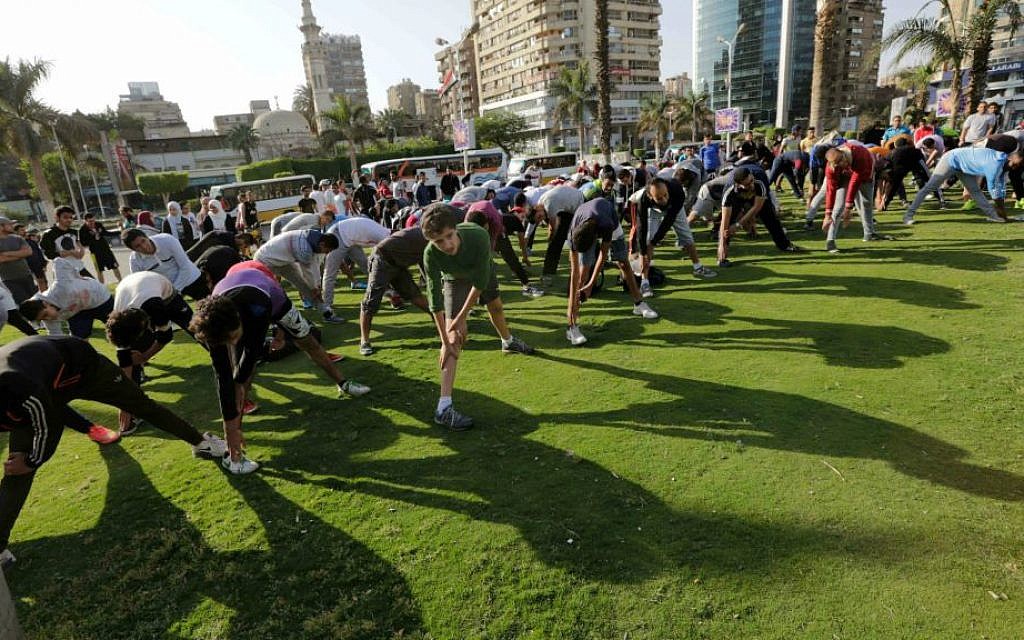 In this Friday, April 10, 2015 picture, Egyptian runners warm up in the Mohandiseen district in Cairo, Egypt. (AP Photo/Amr Nabil)