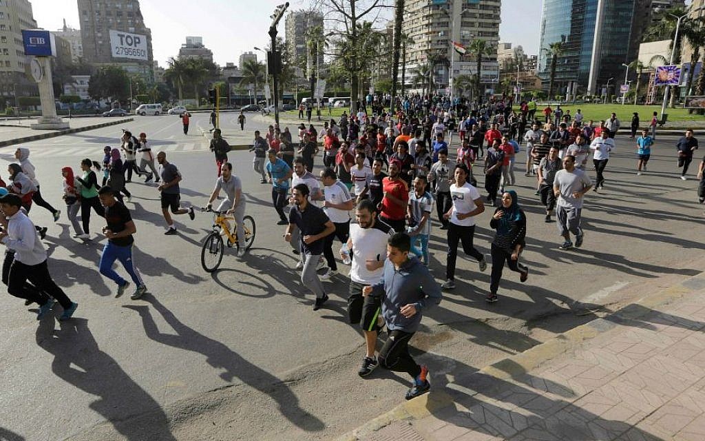 FILE - In this Friday, April 10, 2015 file photo, runners take advantage of Cairo's empty streets during an organized run in the Mohandisseen district of Egypt's capital. (AP Photo/Amr Nabil)