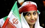In this June 2, 2014 photo, an Iranian woman holds an Iranian flag during a ceremony in Tehran for the national soccer team. (AP/Ebrahim Noroozi)