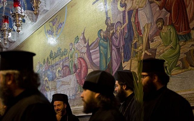 Greek Orthodox priests hold palm fond in the Church of the Holy Sepulcher, traditionally believed by many to be the site of the crucifixion and burial of Jesus Christ during Orthodox Palm Sunday, in Jerusalem, Sunday, April 5, 2015. (photo credit: AP/Ariel Schalit)) Greek Orthodox priests hold palm fond in the Church of the Holy Sepulcher, traditionally believed by many to be the site of the crucifixion and burial of Jesus Christ during Orthodox Palm Sunday, in Jerusalem, Sunday, April 5, 2015. (photo credit: AP/Ariel Schalit)