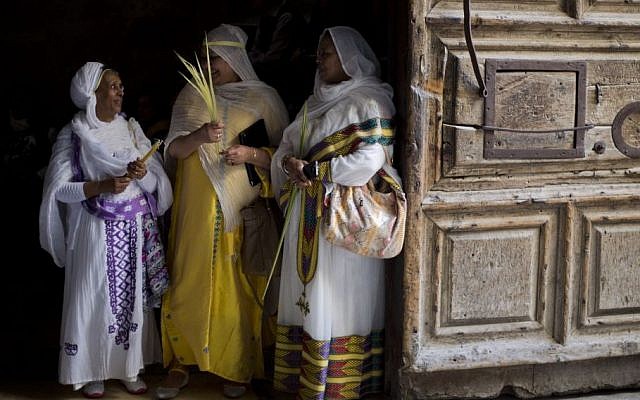 Orthodox Christian women hold palm fond's at the Church of the Holy Sepulcher, traditionally believed by many to be the site of the crucifixion and burial of Jesus Christ during Orthodox Palm Sunday, in Jerusalem, Sunday, April 5, 2015. (photo credit: AP/Ariel Schalit)