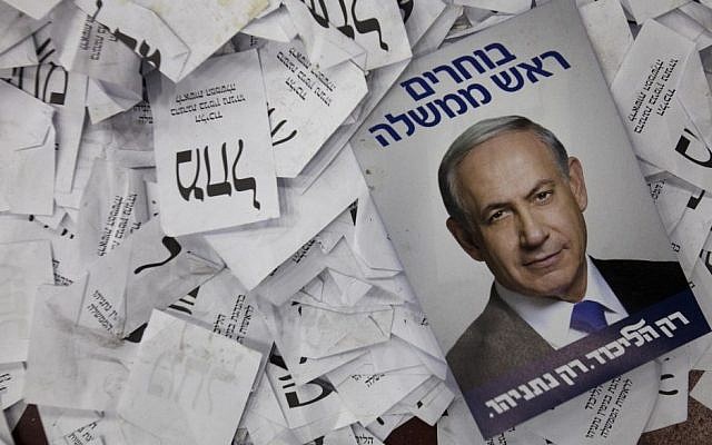 This March 18, 2015, photo, shows a Prime Minister Benjamin Netanyahu election campaign poster lying among ballot papers at his party's election headquarters in Tel Aviv. (AP/Dan Balilty) This March 18, 2015, photo, shows a Prime Minister Benjamin Netanyahu election campaign poster lying among ballot papers at his party's election headquarters in Tel Aviv. (AP/Dan Balilty)