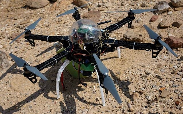 In this photo taken Thursday, March 19, 2015, a six-bladed drone casts a shadow on a heavily looted 5,000-year-old cemetery, known as Fifa, in southern Jordan. (AP Photo/Sam McNeil)