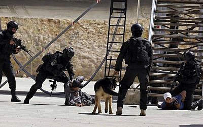 Jordanian forces conduct a military drill as part of the 7th Annual International Warrior Competition hosted by the King Abdullah Special Operations Training Center (KASOTC), Sunday, April 19, 2015, Amman, Jordan. (AP Photo/Raad Adayleh)