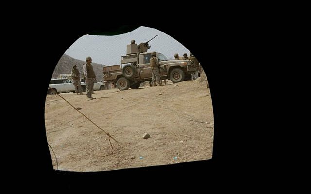 Saudi soldiers are seen through a tent positioned at the Saudi border with Yemen in Jazan, Saudi Arabia, Monday, April 20, 2015. (AP Photo/Hasan Jamali)