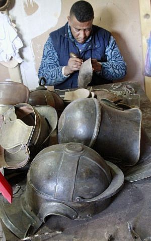 A Moroccan member of the costumes department puts the finishing touches on Roman helmet for the TV series A.D. in the city of Ouarzazate, Morocco. (photo credit: AP Photo/ Paul Schemm) A Moroccan member of the costumes department puts the finishing touches on Roman helmet for the TV series A.D. in the city of Ouarzazate, Morocco. (photo credit: AP Photo/ Paul Schemm)