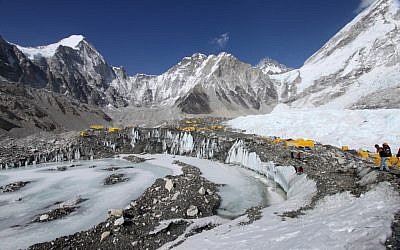 Tents are seen set up for climbers on the Khumbu Glacier, with Mount Khumbutse, center, and Khumbu Icefall, right, seen in background, at Everest Base Camp in Nepal on April 11, 2015. An avalanche triggered by a massive earthquake in Nepal smashed into a base camp between the Khumbu Icefall, a notoriously treacherous rugged area of collapsed ice and snow, and the base camp where most climbing expeditions are, said Ang Tshering of the Nepal Mountaineering Association. (photo credit: AP Photo/Tashi Sherpa, File)