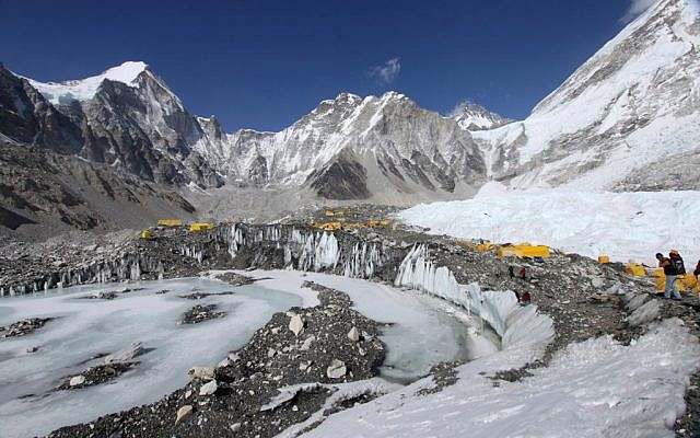 Tents are seen set up for climbers on the Khumbu Glacier, with Mount Khumbutse, center, and Khumbu Icefall, right, seen in background, at Everest Base Camp in Nepal on April 11, 2015. An avalanche triggered by a massive earthquake in Nepal smashed into a base camp between the Khumbu Icefall, a notoriously treacherous rugged area of collapsed ice and snow, and the base camp where most climbing expeditions are, said Ang Tshering of the Nepal Mountaineering Association. (photo credit: AP Photo/Tashi Sherpa, File)
