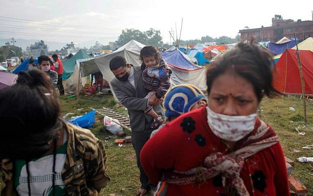 Nepalese people prepare to go back home after sleeping on open grounds for four nights to be safe from earthquake in Kathmandu, Nepal, Wednesday, April 29, 2015. (AP Photo/Niranjan Shrestha)