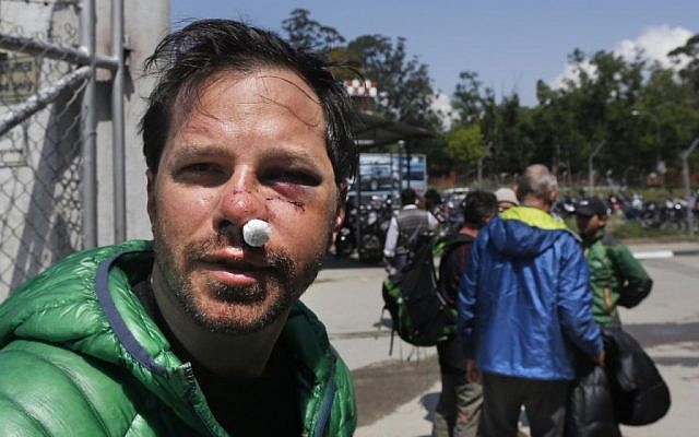 US citizen Michael Churton, 38, from New York, who was injured during an avalanche resulting from Saturday’s earthquake at the base camp of the mount Everest, arrives at the domestic airport in Kathmandu, Nepal, Monday, April 27, 2015. (photo credit: AP/Manish Swarup) US citizen Michael Churton, 38, from New York, who was injured during an avalanche resulting from Saturday’s earthquake at the base camp of the mount Everest, arrives at the domestic airport in Kathmandu, Nepal, Monday, April 27, 2015. (photo credit: AP/Manish Swarup)