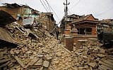 A Nepalese man walks through destruction caused by Saturday's earthquake, in Bhaktapur, Nepal, Sunday, April 26, 2015.  (photo credit: AP Photo/Niranjan Shrestha)