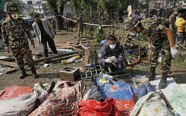 Rescue teams' members identify bodies dug out of the collapsed Sitapyla church in Kathmandu, Nepal, Monday, April 27, 2015. (photo credit: AP/Wally Santana)