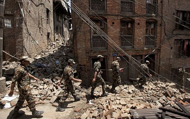 Members of the Nepalese army walk through a damaged area caused by Saturday's earthquake, in Bhaktapur, on the outskirts of Kathmandu, Nepal, Monday, April 27, 2015. (photo credit: AP /Niranjan Shrestha)