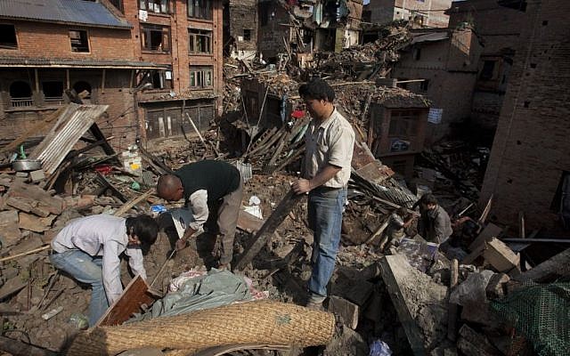 A Nepalese family collects belongings from their home destroyed in Saturday's earthquake, in Bhaktapur on the outskirts of Kathmandu, Nepal, Monday, April 27, 2015. (photo credit: AP/Niranjan Shrestha) A Nepalese family collects belongings from their home destroyed in Saturday's earthquake, in Bhaktapur on the outskirts of Kathmandu, Nepal, Monday, April 27, 2015. (photo credit: AP/Niranjan Shrestha)