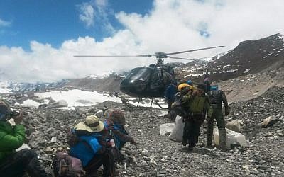 A rescue chopper lands carrying people from higher camps to Everest Base Camp, Nepal, Monday, April 27, 2015. (photo credit: AP/Nima Namgyal Sherpa)
