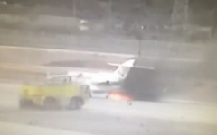 A plane catches fire on the tarmac at Ben Gurion Airport (screen capture: Channel 2)