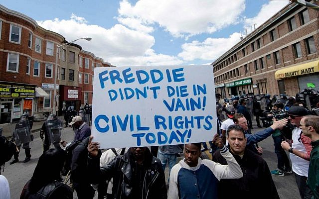 People gather Tuesday, April 28, 2015, in Baltimore, in the aftermath of rioting following Monday's funeral for Freddie Gray, who died in police custody. (AP Photo/Matt Rourke) People gather Tuesday, April 28, 2015, in Baltimore, in the aftermath of rioting following Monday's funeral for Freddie Gray, who died in police custody. (AP Photo/Matt Rourke)