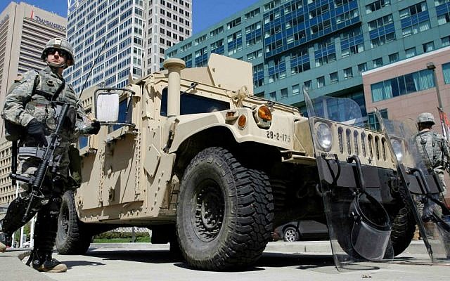 Maryland National Guardsmen patrol near downtown businesses in Baltimore, Tuesday, April 28, 2015, a day after looting and arson erupted following the funeral of Freddie Gray. (AP Photo/Patrick Semansky)