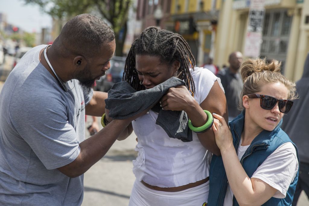 Shameeka Dream, of Baltimore, Md. is helped after being sprayed in the eyes with a crowd dispersement during a demonstration after an evening of riots following the funeral of Freddie Gray on Tuesday, April 28, 2015, in Baltimore. (photo credit: AP Photo/Evan Vucci) Shameeka Dream, of Baltimore, Md. is helped after being sprayed in the eyes with a crowd dispersement during a demonstration after an evening of riots following the funeral of Freddie Gray on Tuesday, April 28, 2015, in Baltimore. (photo credit: AP Photo/Evan Vucci)