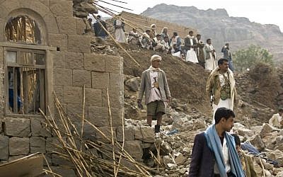 Yemenis stand amid the rubble of houses destroyed by Saudi-led airstrikes in a village near Sanaa, Yemen, April 4, 2015. (photo credit: AP/Hani Mohammed, File)