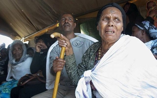 Ahaza Kassaye (R), the mother of Eyasu Yikunoamlak who was held captive in Libya and killed by the Islamic State group, mourns his death with relatives and friends on April 21, 2015 during a gathering in the Ethiopian capital Addis Ababa. (Photo credit: AFP/ ELIAS ASMARE)