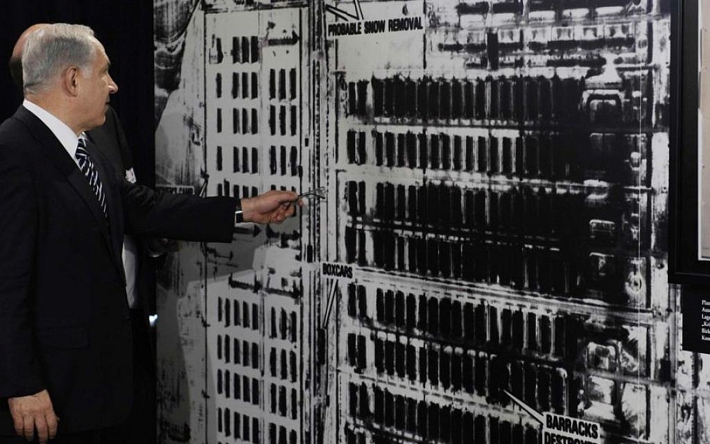 Prime Minister Benjamin Netanyahu in Berlin on August 27, 2009, examining a US military aerial photo of Auschwitz-Birkenau (photo credit: AP/Rainer Jensen, pool) Prime Minister Benjamin Netanyahu in Berlin on August 27, 2009, examining a US military aerial photo of Auschwitz-Birkenau (photo credit: AP/Rainer Jensen, pool)