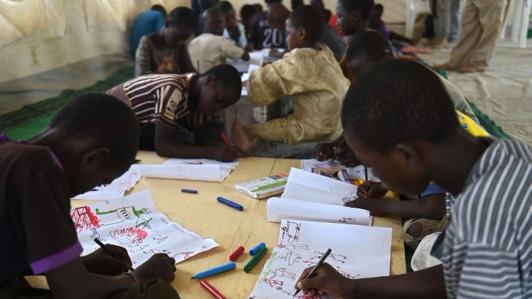 Young Nigerian refugees draw on April 6, 2015 during a therapy program managed by UNICEF in a refugee camp near Baga Sola (photo creidt: AFP /PHILIPPE DESMAZES) Young Nigerian refugees draw on April 6, 2015 during a therapy program managed by UNICEF in a refugee camp near Baga Sola (photo creidt: AFP /PHILIPPE DESMAZES)