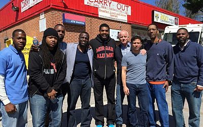 Rabbi Daniel Burg joins African-American faith leaders and thousands of volunteers to clean up west Baltimore, April 2015. (Courtesy: Daniel Burg)