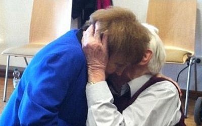 Auschwitz survivor Eva Kor and former SS guard Oskar Groening embrace during the latter's trial on 300,000 counts of accessory to murder. (Photo credit: screenshot/Daily Mail)