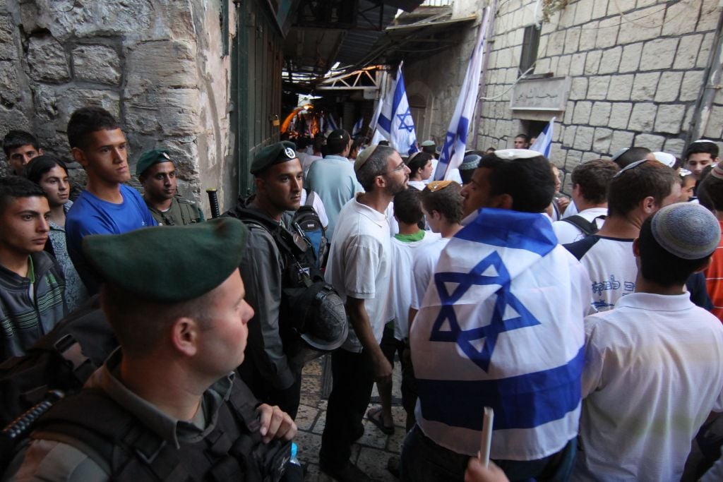 Israeli border police guard Jerusalem Day marchers as they walk through the Muslim Quarter of the Old City, June 1, 2011 (photo credit: Nati Shohat/Flash90)