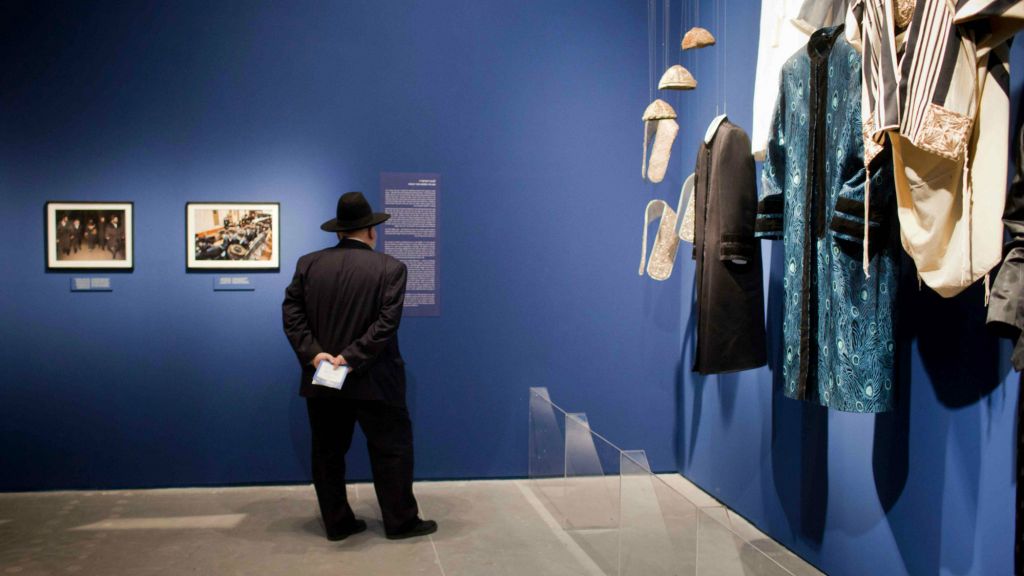 Visitors looking at photographs displayed at the Israel Museum exhibition "A World Apart Next Door: Glimpses into the life of Hasidic Jews" in Jerusalem on June 20, 2012. The ethnographic exhibition highlights facets of the culture of the Hasidic Jews. (Photo credit: Yonatan Sindel/Flash90) Visitors looking at photographs displayed at the Israel Museum exhibition "A World Apart Next Door: Glimpses into the life of Hasidic Jews" in Jerusalem on June 20, 2012. The ethnographic exhibition highlights facets of the culture of the Hasidic Jews. (Photo credit: Yonatan Sindel/Flash90)