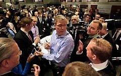 Former Florida gov. Jeb Bush (center), mingles at a 'Politics and Eggs' event, a breakfast fixture for 2016 presidential prospects, at Saint Anselm College in Manchester, NH, Friday, April 17, 2015. (photo credit: AP/Elise Amendola)