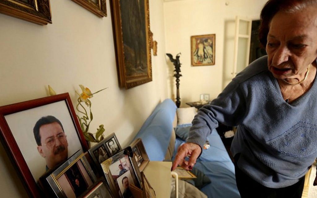 Marie Mansourati, 83, adjusts pictures of her kidnapped son Dani, more than two decades after he was taken by Syrian troops to Damascus, at her house in Beirut on April 8, 2015. (photo credit: AFP/ Joseph Eid) Marie Mansourati, 83, adjusts pictures of her kidnapped son Dani, more than two decades after he was taken by Syrian troops to Damascus, at her house in Beirut on April 8, 2015. (photo credit: AFP/ Joseph Eid)