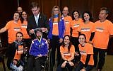 Maickel Melamed, in a wheelchair and flanked by his support team, receives a medal from Boston Mayor Martin Walsh, April 21, 2015. (Photo Credit: JTA/City of Boston, Mayor’s Office)