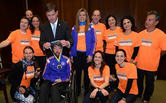 Maickel Melamed, in a wheelchair and flanked by his support team, receives a medal from Boston Mayor Martin Walsh, April 21, 2015. (Photo Credit: JTA/City of Boston, Mayor’s Office) Maickel Melamed, in a wheelchair and flanked by his support team, receives a medal from Boston Mayor Martin Walsh, April 21, 2015. (Photo Credit: JTA/City of Boston, Mayor’s Office)