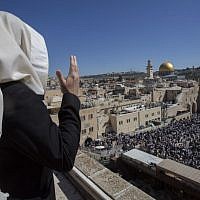 A man in a prayer shawl looks down at the thousands gathered at the Western Wall for the annual priestly blessing April 6, 2015. (Photo credit: Yonatan Sindel/Flash90) A man in a prayer shawl looks down at the thousands gathered at the Western Wall for the annual priestly blessing April 6, 2015. (Photo credit: Yonatan Sindel/Flash90)