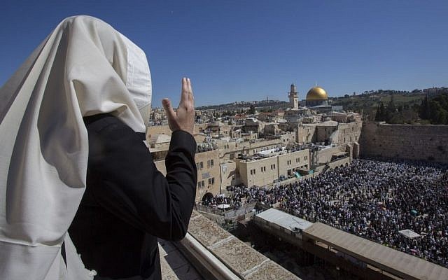 A man in a prayer shawl looks down at the thousands gathered at the Western Wall for the annual priestly blessing April 6, 2015. (Photo credit: Yonatan Sindel/Flash90) A man in a prayer shawl looks down at the thousands gathered at the Western Wall for the annual priestly blessing April 6, 2015. (Photo credit: Yonatan Sindel/Flash90)