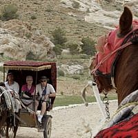 Tourists ride a horse cart at the ancient city of Petra in Jordan on March 25, 2015. Four Paws and the Jordanian Princess Alia Foundation (PAF) work for the improvement of the health and working conditions of horses and donkeys in Petra, providing veterinary treatment and training for the owners. (Photo credit: AFP/ KHALIL MAZRAAWI) Tourists ride a horse cart at the ancient city of Petra in Jordan on March 25, 2015. Four Paws and the Jordanian Princess Alia Foundation (PAF) work for the improvement of the health and working conditions of horses and donkeys in Petra, providing veterinary treatment and training for the owners. (Photo credit: AFP/ KHALIL MAZRAAWI)