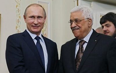 Russian President Vladimir Putin (L) shakes hands with his Palestinian counterpart Mahmoud Abbas during their meeting at the Novo-Ogaryovo residence outside Moscow on April 13, 2015. (Photo credit: AFP/ POOL / SERGEI ILNITSKY)