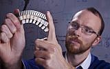 Assistant Professor Stephan Rudykh with a sample of the durable material (photo credit: Technion -- Israel Institute of Technology)