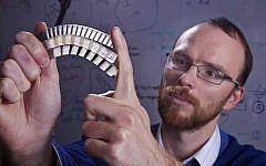 Assistant Professor Stephan Rudykh with a sample of the durable material (photo credit: Technion -- Israel Institute of Technology)