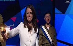 Israeli Arab journalist Lucy Aharish lights a torch at the Independence Day Ceremony on April 22, 2015 (screen capture: Channel 2)