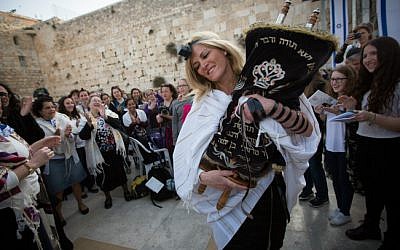 Women dance with a Torah scroll as they attend a monthly prayer service at the Western Wall, Judaism's holiest site, on April 20, 2015 (photo credit: Miriam Alster/Flash90) 