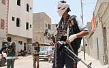 Yemeni fighters, opposing the Houthi rebels and supporting government forces loyal to President Abd Rabbuh Mansour Hadi, stand on a street in Aden's northern district of Dar Saad on April 12, 2015. (AFP/Saleh al-Obeidi)