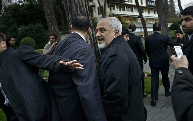 Iranian Foreign Minister Javad Zarif talks to members of the media while walking through a courtyard at the Beau Rivage Palace Hotel during an extended round of talks April 1, 2015 in Lausanne, Switzerland (photo credit: AFP /BRENDAN SMIALOWSKI/POOL) 